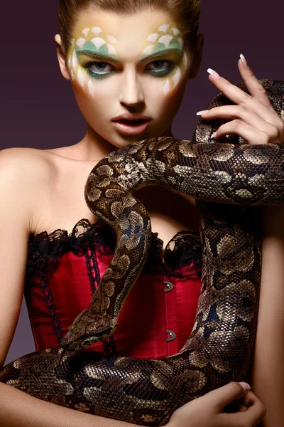 Serpent. Fantasy. Fancy Woman holding Tamed Snake in Hands — Stock Photo, Image