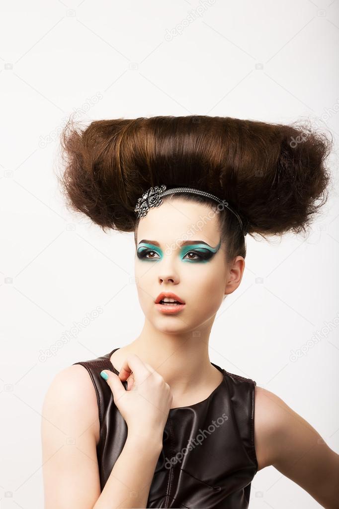 Glamour. Vitality. Portrait of Unusual Brunette with Extraordinary Festive Hairdo