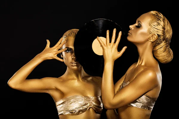 Fetish. Women DJs holding Retro Vinyl Record. Fantastic Gold Badyart. Performance — Stock Photo, Image