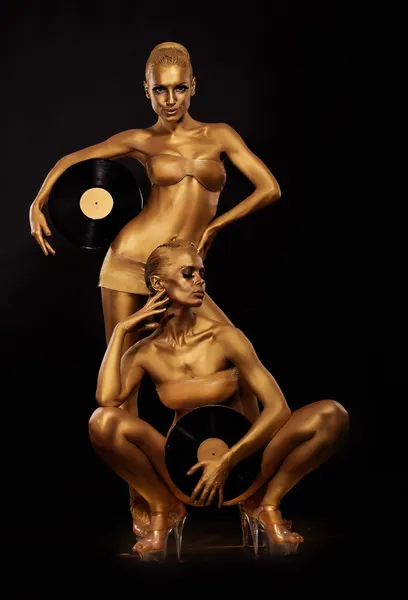 Gold Bodyart. Colorear. Golden Women Silhouettes with Retro Vinyl Records over black. Concepto de arte creativo —  Fotos de Stock