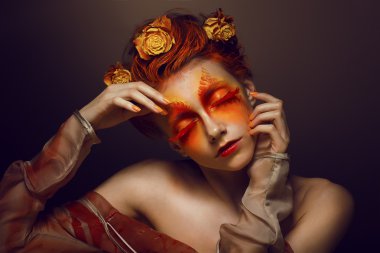 Bodyart. Imagination. Artistic Woman with Red - Gold Makeup and Flowers. Coloring clipart