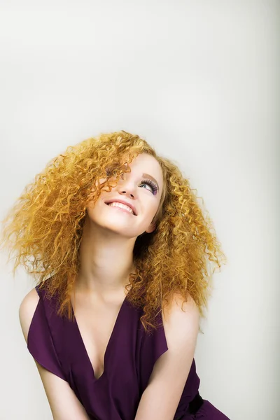 Mode de vie. Radieuse femme heureuse aux cheveux bouclés dorés souriant. Émotions positives — Photo