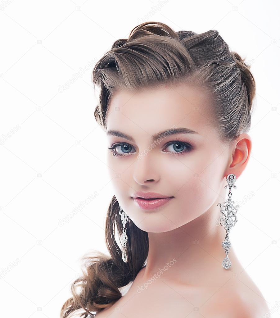 Jewelry. Glamorous Smiling Brunette with Brilliant Earrings. Sophistication
