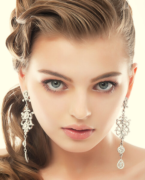 Jewelry. Portrait of Gorgeous Exquisite Woman with Shiny Earrings. Refinement