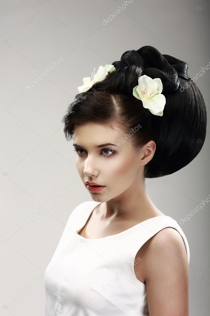Face of Beautiful Brunette Bride Fashion Model. Elegant Hairdo with Vernal Flowers
