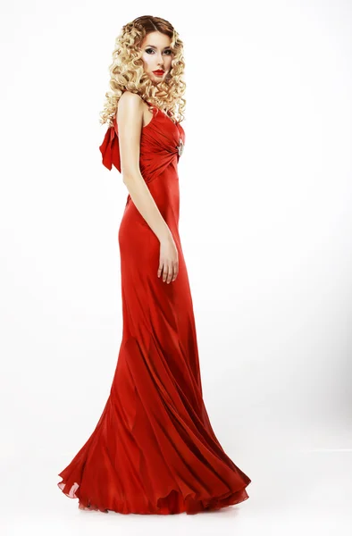 Lujo. Longitud completa de la señora elegante en vestido rojo satinado. Pelo rubio muy rizado — Foto de Stock