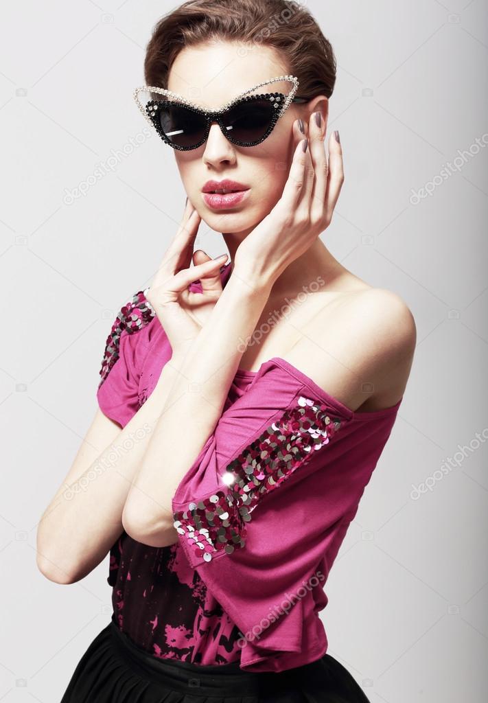 High Fashion. Glamorous Elegant Woman in Dark Sunglasses. Magnetism