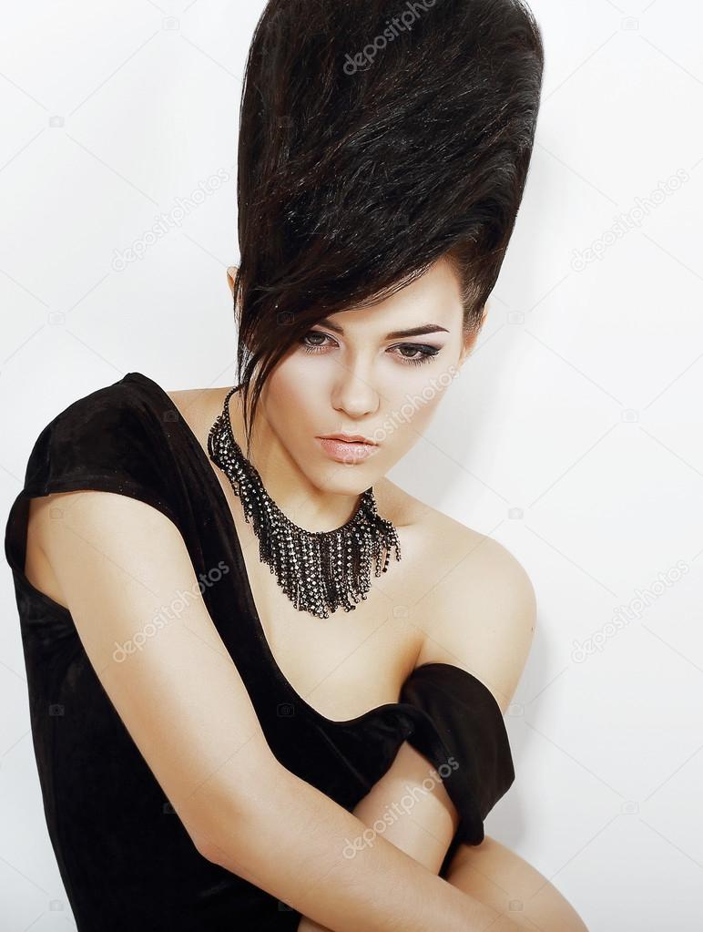 Sentiment. Pensive Bright Woman with Black Updo Hair and Necklace