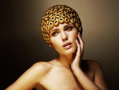Creativity. Surreal Portrait of Stylized Woman with Golden Headwear as a Helmet clipart
