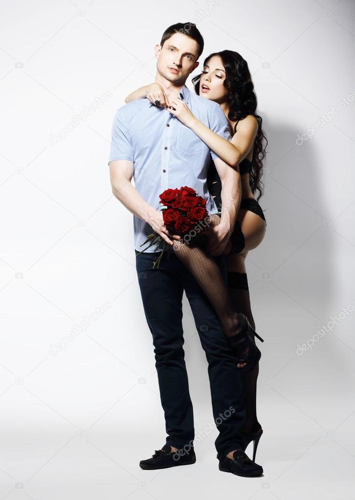 Allurement. Affectionate Romantic Couple with Bouquet of Flowers