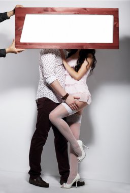 Couple and Board with White Blank Space clipart