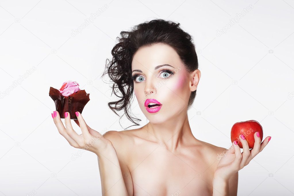 Dieting. Unsure Bewildered Girl Choosing Apple or Cake