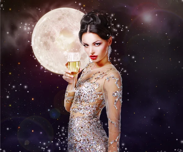 Gorgeous woman with a glass of champagne on the background of a Stock Photo