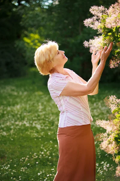 Gardening. Gracious Senior Woman and Flowers — Stock Photo, Image