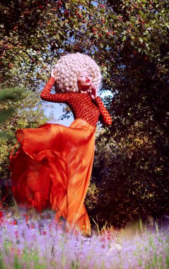 Creativity. Ultramodern Woman Blond in Artificial Huge Futuristic Wig Outside clipart