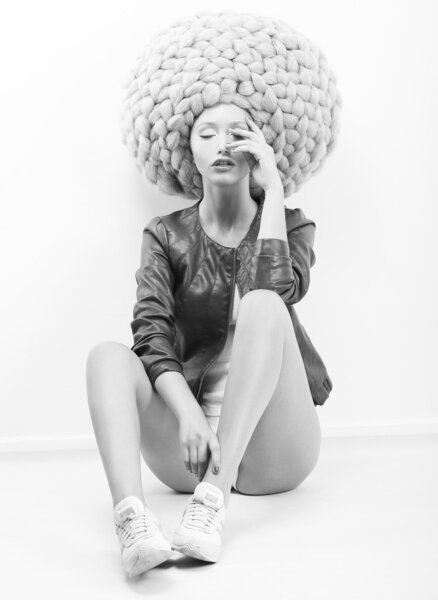 Art Modern. Futuristic Woman in Trendy Huge Lust Wig with Braids