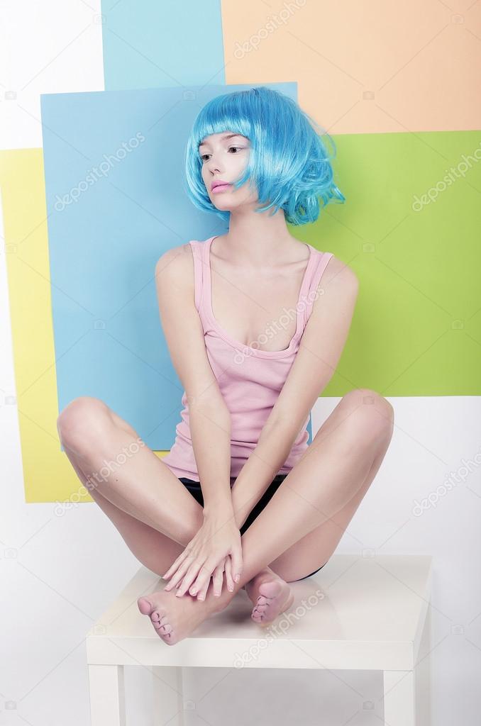 Patchwork. Funky Girl in Azure Wig Sitting in Studio on White Chair