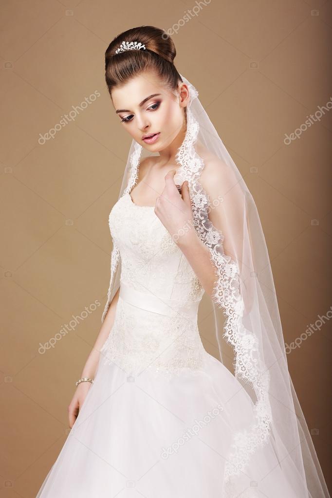 Femininity. Sentimental Bride in White Dress and Openwork Veil