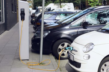 Recharge. Electric Car in Free Charging Station. Environmentally Friendly Transport