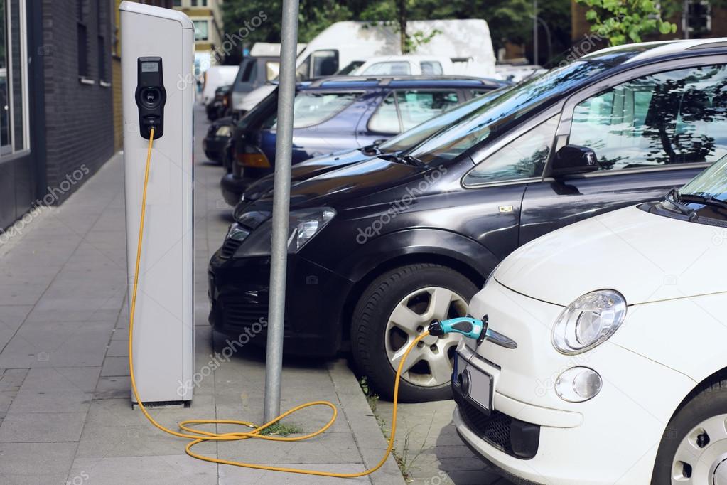 Recharge. Electric Car in Free Charging Station. Environmentally Friendly Transport