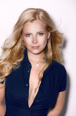 uzun kıvırcık saçları ve kazanan bir gülümseme ile zarif dostu güzel sarışın kadın