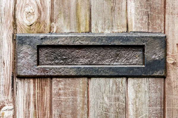 Old letterbox in a paneled door — Stock Photo, Image