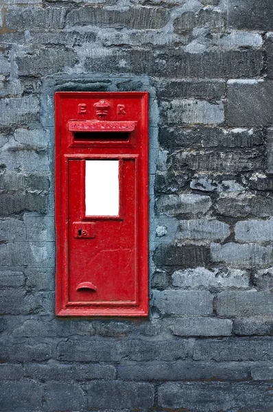 Red post box set in wall — Stock Photo, Image