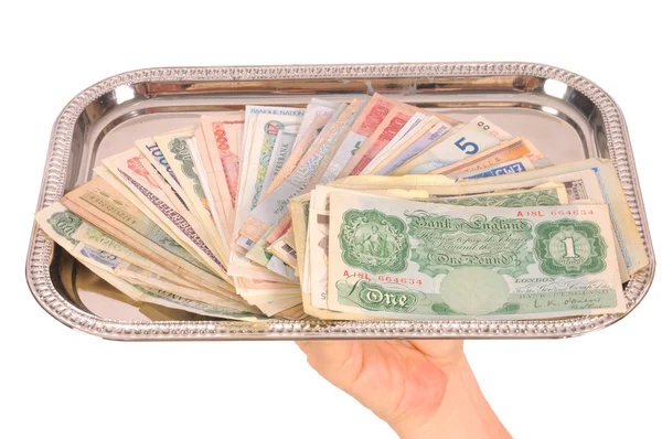 Hand holding tray of world monies, isolated on white — Stock Photo, Image