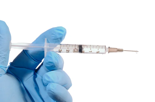 Medical gloved hand holding syringe — Stock Photo, Image