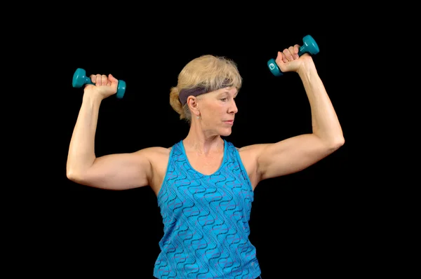Attractive baby-boomer exercising with weights — Stock Photo, Image