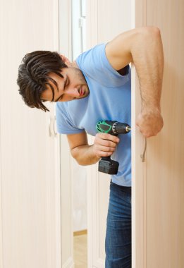 Man repairing the door handle furniture clipart