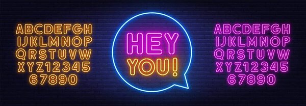 Hey you neon sign on brick wall background.