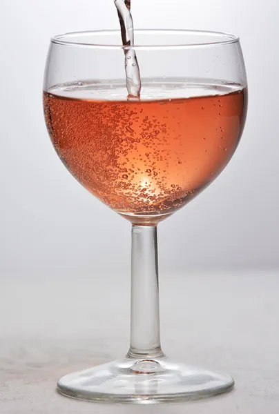 Wine glass with red sparkling drink — Stock Photo, Image