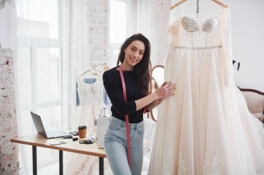 Bu benim işim ve bitti. Kadın moda tasarımcısı atölyedeki yeni kıyafetler üzerinde çalışıyor..