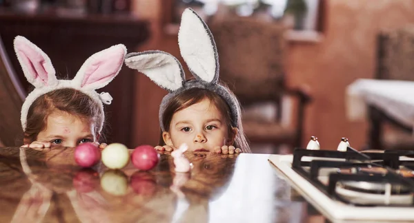Funny Two Sisters Bunny Ears Looking Painted Eggs Table — Stock Photo, Image