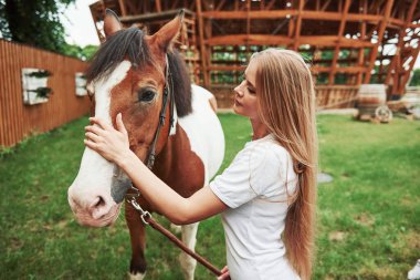 Genç bayan binici. Gündüz vakti atıyla çiftlikte mutlu bir kadın.