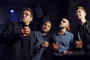 Gece hayatı kavramı. İnsanlar kulüpte eğleniyor. Ellerinde alkolle.