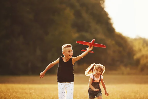 Girl Boy Having Fun Outdoors Red Toy Airplane Hands — Stock Photo, Image