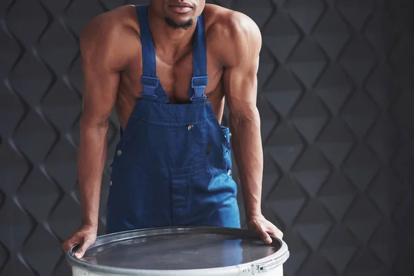 Strong Man Leaning Barrel Young African American Worker Blue Uniform — Stock Photo, Image