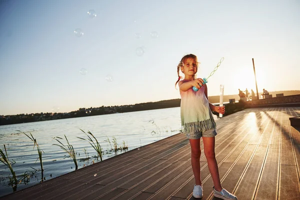 Evening Time Happy Little Girl Playing Bubbles Lake Park — Stock Photo, Image