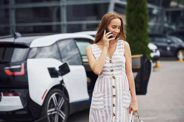 Använda Telefonen Medan Väntar Laddningen Kvinnan Stationen Vid Dagtid Helt — Stockfoto