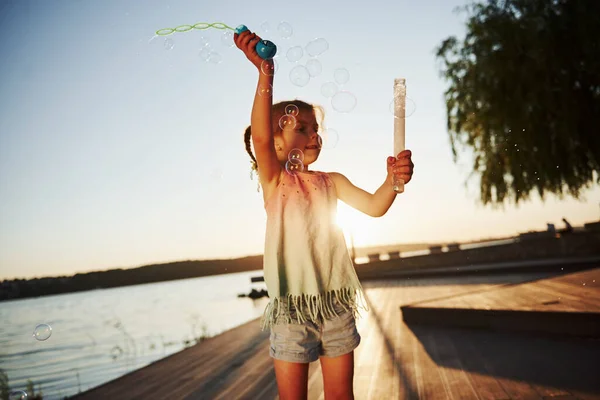 Evening Time Happy Little Girl Playing Bubbles Lake Park — Stock Photo, Image