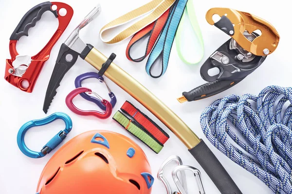 stock image Must have things. Top view. Climbing equipment for the safeness lying on the white table. Conception of extreme sports.