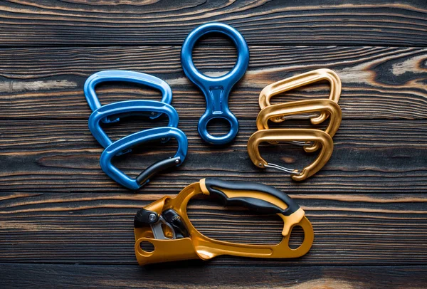 Creative Design Isolated Photo Climbing Equipment Parts Carabiners Lying Wooden — Stock Photo, Image