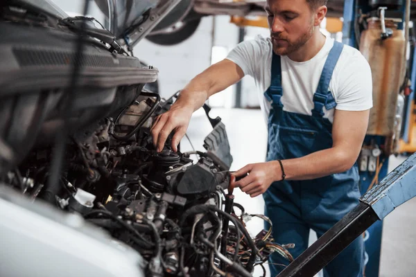 Arabanın Motoru Mavi Üniformalı Işçi Otomobil Salonunda Çalışıyor — Stok fotoğraf