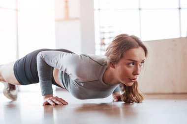Çalışkandır. Sportif genç bir kadın sabah spor salonunda spor yapıyor..