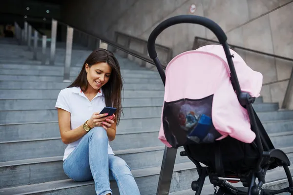 Sitting Stairs Smartphone Hands Pink Pram Nearby Pretty Young Woman — Stock Photo, Image