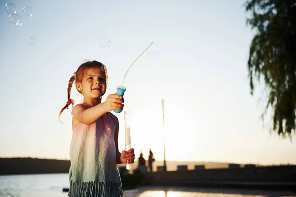 Evening Time Happy Little Girl Playing Bubbles Lake Park — Stock Photo, Image