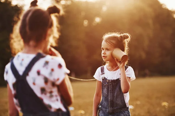 Two Female Kids Stands Field Talking Using String Can Phone — Stock Photo, Image