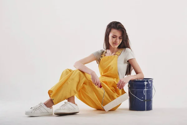 Having Break Brunette Woman Yellow Uniform Sitting White Background Studio — Stock Photo, Image